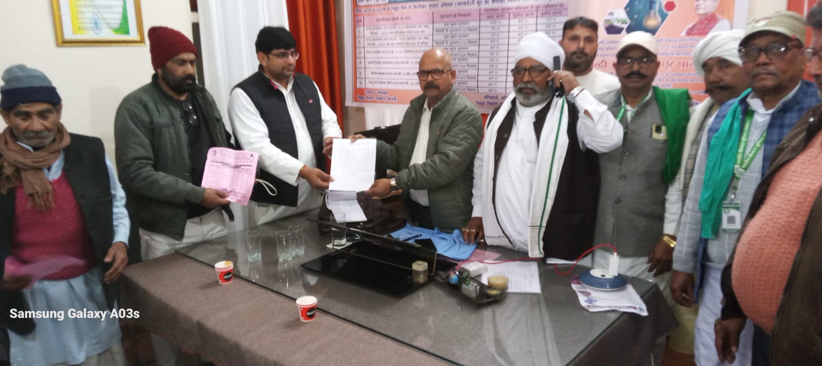 UP Bijnor News: The Superintending Engineer of Bijnor Electricity Department is distributing pamphlets of OTS scheme in his office