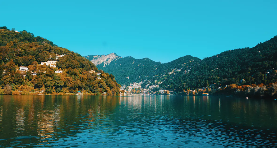 Nainital Monsoon 2026: Naini Lake filled with rainwater during Nainital Monsoon 2026, with mist-covered hills and cloudy weather in Nainital.